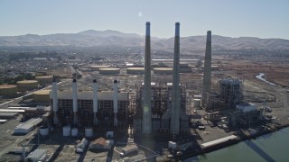 AXSF08_084 - 5K aerial stock footage tilt from piers to reveal a power plant with smoke stacks in Pittsburg, California