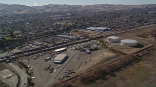 AXSF08_086 - 5K aerial stock footage track a train traveling near residential neighborhoods; Pittsburg, California