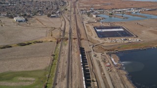 AXSF08_089 - 5K aerial stock footage of tracking a train traveling through Pittsburg, California