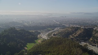 AXSF09_012 - 5K aerial stock footage fly over Oakland Hills revealing upscale hillside homes and freeway, Oakland, California