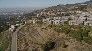AXSF09_013 - 5K aerial stock footage of flying by hilltop apartment buildings, Oakland Hills, California