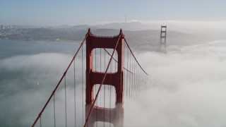 AXSF09_029 - 5K aerial stock footage orbit the Golden Gate Bridge and fog, reveal Alcatraz and Downtown San Francisco, California