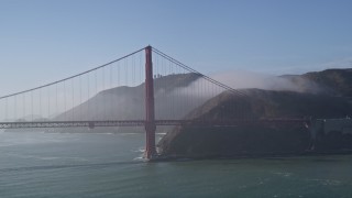 AXSF09_045 - 5K aerial stock footage of flying by the Golden Gate Bridge, light fog, San Francisco, California