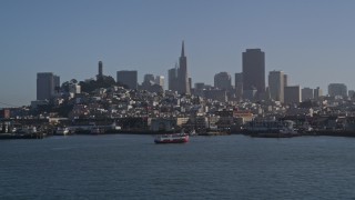 AXSF09_053 - 5K aerial stock footage of Fisherman's Wharf and city skyline seen from the bay, reveal Pier 39 and Coit Tower, Downtown San Francisco, California