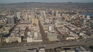 AXSF09_069 - 5K aerial stock footage of flying by 880 freeway and urban neighborhoods, revealing I- 980, Downtown Oakland, and Lake Merritt, California