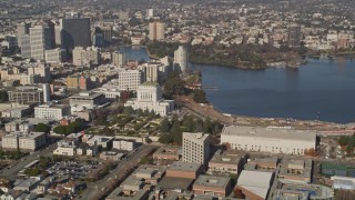 AXSF09_070 - 5K aerial stock footage of flying by Lake Merritt and Downtown Oakland, California