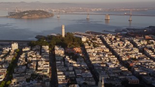 AXSF10_005 - 5K aerial stock footage of zooming in on Coit Tower in North Beach, San Francisco, California, sunset