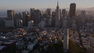 AXSF10_006 - 5K aerial stock footage flying by Coit Tower and the Financial District skyline, Downtown San Francisco, California, sunset