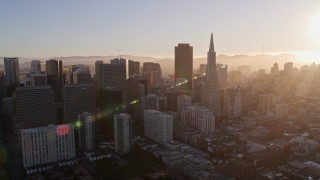 AXSF10_007 - 5K aerial stock footage of flying by downtown skyscrapers and Transamerica Pyramid, Downtown San Francisco, California at sunset