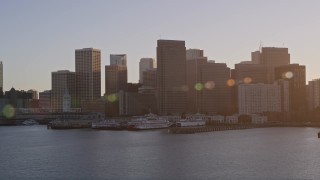 AXSF10_013 - 5K aerial stock footage of waterfront skyscrapers and Ferry Building in Downtown San Francisco, California at sunset