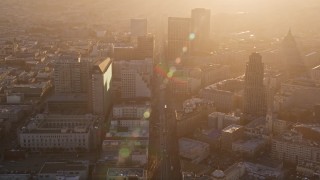 AXSF10_017 - 5K aerial stock footage of flying over Market Street through Civic Center, Downtown San Francisco, California at sunset