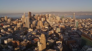 AXSF10_019 - 5K aerial stock footage of flying by city buildings and Market Street, Downtown San Francisco, California, sunset