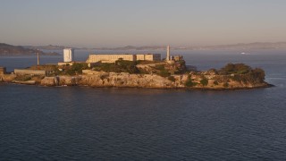 AXSF10_027 - 5K aerial stock footage of approaching Alcatraz prison San Francisco, California, sunset