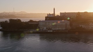 AXSF10_028 - 5K aerial stock footage circling low around the island of Alcatraz, San Francisco, California, sunset