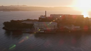 AXSF10_029 - 5K aerial stock footage of flying around Alcatraz prison in San Francisco, California, sunset