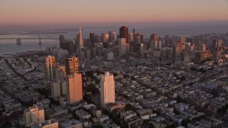 AXSF10_057 - 5K aerial stock footage tilt from Russian Hill apartment buildings to reveal Downtown San Francisco, California, twilight
