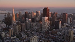 AXSF10_058 - 5K aerial stock footage tilt from apartment buildings to reveal Downtown San Francisco skyscrapers, California, sunset
