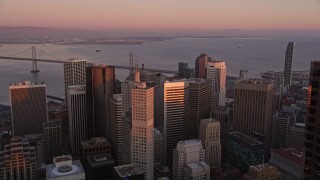 AXSF10_059 - 5K aerial stock footage pan across Transamerica Pyramid and skyscrapers to One Rincon Hill in Downtown San Francisco, California, sunset