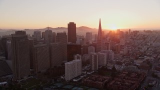 AXSF10_062 - 5K aerial stock footage flying by downtown skyscrapers, Downtown San Francisco, California, sunset