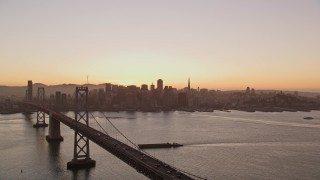 AXSF10_066 - 5K aerial stock footage flyby Bay Bridge with a view of Downtown San Francisco, California, twilight