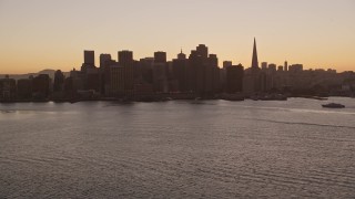 AXSF10_067 - 5K aerial stock footage of the Ferry Building and Downtown San Francisco skyline, California, sunset