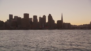 AXSF10_068 - 5K aerial stock footage low altitude approach to Ferry Building and Downtown San Francisco skyline, California, twilight