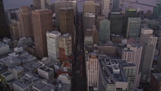 AXSF10_077 - 5K aerial stock footage tilt from Market Street revealing Downtown San Francisco skyscrapers, California, twilight