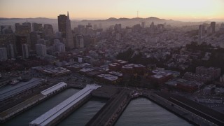 AXSF10_079 - 5K aerial stock footage pan across San Francisco Bay to reveal Coit Tower, Fisherman's Wharf, and downtown, California, sunset