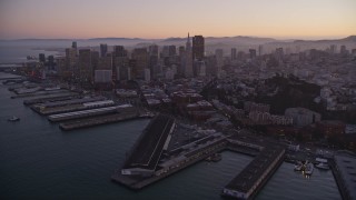 AXSF10_080 - 5K aerial stock footage fly away from piers, Coit Tower, and Downtown San Francisco, California, twilight