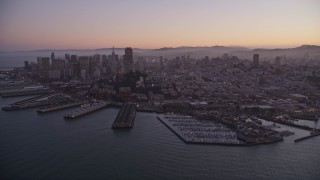 AXSF10_081 - 5K aerial stock footage of downtown skyscrapers and Coit Tower, reveal Pier 39, Fisherman's Wharf, San Francisco, California, twilight