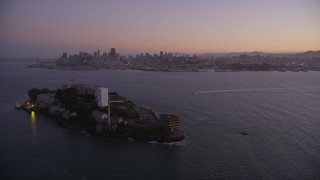 AXSF10_082 - 5K aerial stock footage of flying away from downtown, revealing Alcatraz, Downtown San Francisco, California, twilight