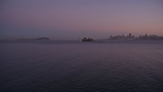 AXSF10_084 - 5K aerial stock footage pan across San Francisco Bay, reveal Alcatraz and Downtown San Francisco skyline, California, twilight
