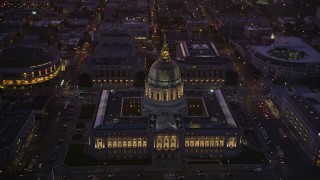 AXSF10_095 - 5K aerial stock footage approach city hall in Civic Center, tilt to opera house and theater, San Francisco, California, twilight