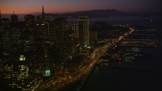 AXSF10_109 - 5K aerial stock footage tilt from heavy traffic on the Bay Bridge, reveal Downtown San Francisco, California, twilight
