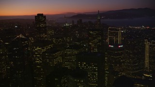 AXSF10_110 - 5K aerial stock footage of panning across the city's tall skyscrapers, Downtown San Francisco, California, twilight