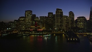 AXSF10_114 - 5K aerial stock footage of the Ferry Building and towering skyscrapers in Downtown San Francisco, California, night