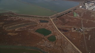 AXSF11_007 - 5K aerial stock footage reverse view of sloughs, reveal homes and Sea Breeze Park, Union City, California