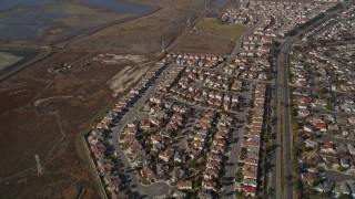 AXSF11_008 - 5K aerial stock footage of flying away from tract homes and marshland, Union City, California
