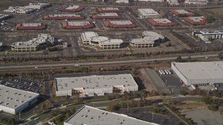 AXSF11_011 - 5K aerial stock footage of flying away from office buildings and warehouses, Newark, California