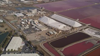 AXSF11_012 - 5K aerial stock footage of flying by Morton Salt Plant and salt marshes, Newark, California