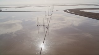 AXSF11_020 - 5K aerial stock footage of following a row of power lines and marshlands, Fremont, California