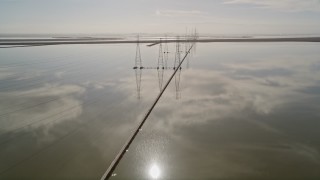 AXSF11_022 - 5K aerial stock footage fly over wetlands while following a row of power lines, Sunnyvale, California