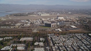 AXSF11_048 - 5K aerial stock footage of flying by Moffett Field and NASA Ames Research Center, Mountain View, California
