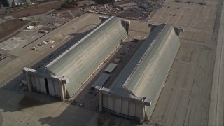 AXSF11_053 - 5K aerial stock footage tilt to reveal Hangar Two, Hangar Three at Moffett Field military base, Mountain View, California
