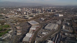 AXSF12_002 - 5K aerial stock footage fly over train tracks and yard, tilt to reveal Downtown San Jose, California