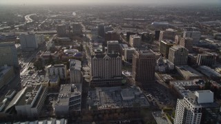 AXSF12_015 - 5K aerial stock footage tilt from apartment buildings and fly over Downtown San Jose toward freeway, California