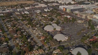 AXSF12_020 - 5K aerial stock footage of shopping center, suburban homes, reveal Winchester Mystery House, San Jose, California