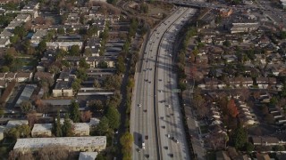AXSF12_023 - 5K aerial stock footage of a reverse view of I-280 freeway with light traffic, San Jose, California