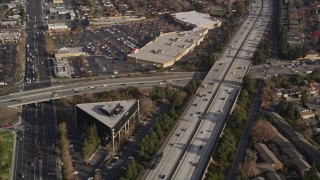 AXSF12_024 - 5K aerial stock footage reverse view of neighborhoods beside Interstate 280, reveal shopping center, San Jose, California