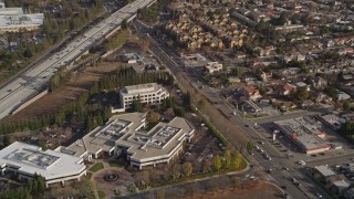 AXSF12_025 - Aerial stock footage of 5K aerial view of a reverse view of 280 freeway, apartment buildings, office buildings, Cupertino, California